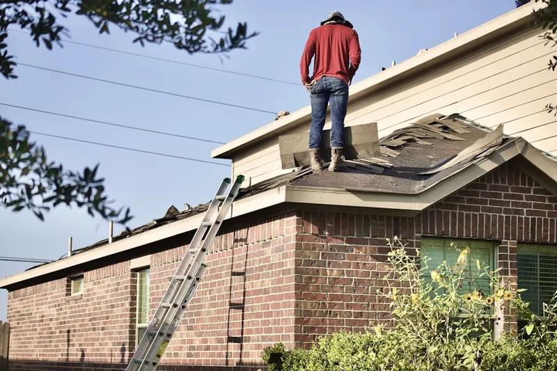 Professional roofer working on a residential roof in Lawnside
